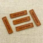 20 etichette finta pelle artigianali sciarpe cappelli toppe PU cucito maglieria